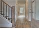 Bright entry hall with hardwood floors, elegant staircase, and neutral color palette at 4045 Andover Cir, Mcdonough, GA 30252