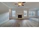 Bright living room with hardwood floors, fireplace, and large windows at 4045 Andover Cir, Mcdonough, GA 30252