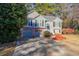 Traditional home featuring an attached two-car garage, complemented by lush landscaping and mature trees at 242 Viola Dr, Dallas, GA 30157
