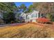 Charming two-story home with a well-manicured lawn and mature trees, showcasing inviting curb appeal at 242 Viola Dr, Dallas, GA 30157