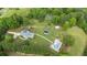 Aerial view of property featuring a pool, solar building, and lush green landscape at 289 Barn Rd, Canton, GA 30115