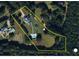 Aerial view showcasing the property lines, home, pool, outbuilding, and surrounding greenery at 289 Barn Rd, Canton, GA 30115