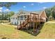 The back of this home features a large deck, screened-in porch, and well-maintained yard at 289 Barn Rd, Canton, GA 30115