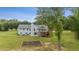 Spacious backyard with deck, patio, and lush greenery; perfect for outdoor living at 289 Barn Rd, Canton, GA 30115