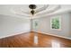 A spacious, airy bedroom boasts hardwood floors and a unique tray ceiling design at 289 Barn Rd, Canton, GA 30115