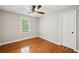 Neutral bedroom with hardwood floors, ceiling fan and a window at 289 Barn Rd, Canton, GA 30115