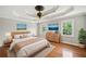 Serene bedroom with tray ceiling, hardwood floors, and an array of bright windows at 289 Barn Rd, Canton, GA 30115