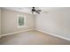 Bedroom with plush carpet, a ceiling fan, and natural light from the window at 289 Barn Rd, Canton, GA 30115