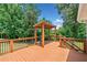 An outdoor deck with a pergola and a built-in grill at 289 Barn Rd, Canton, GA 30115