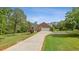 A long concrete driveway leads up to a brick home with an attached two-car garage at 289 Barn Rd, Canton, GA 30115