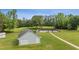 A detached two car garage sits on manicured lawn with walkway leading to pool at 289 Barn Rd, Canton, GA 30115