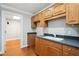 This kitchen features wood cabinets with modern countertops and hardwood floors at 289 Barn Rd, Canton, GA 30115