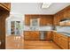 Traditional kitchen with wood cabinets, granite countertops, and stainless steel appliances at 289 Barn Rd, Canton, GA 30115