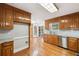 Bright kitchen with wood cabinets, stainless appliances and open to the dining area with hardwood floors at 289 Barn Rd, Canton, GA 30115