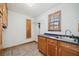 Well-equipped laundry room featuring wooden cabinets, sink, and window for natural light at 289 Barn Rd, Canton, GA 30115