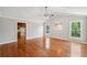 Bright living room with hardwood floors, neutral walls, and an open doorway to a kitchen area at 289 Barn Rd, Canton, GA 30115