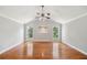 Spacious living room featuring hardwood floors, gray walls, and ample natural light from two large windows at 289 Barn Rd, Canton, GA 30115