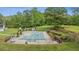 Aerial view of a covered pool in a backyard lined with bushes and trees at 289 Barn Rd, Canton, GA 30115
