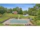 An aerial view of a large, covered in-ground pool, surrounded by lush greenery and a charming pool house at 289 Barn Rd, Canton, GA 30115