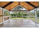 Inviting screened porch with high vaulted wood ceilings, fan, and a scenic backyard view at 289 Barn Rd, Canton, GA 30115