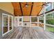Inviting screened porch with wood ceilings, fan, and sliding glass door at 289 Barn Rd, Canton, GA 30115