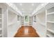 Spacious walk-in closet with custom shelving, cabinetry, and a window, providing ample storage at 289 Barn Rd, Canton, GA 30115