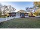 Backyard featuring green grass, a white fence, mature trees, and the home's exterior at 1526 N Cherokee N Rd, Social Circle, GA 30025