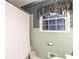 Bright bathroom showcasing tile, a window, a shower curtain, and a toilet at 1526 N Cherokee N Rd, Social Circle, GA 30025