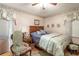 Comfortable bedroom with a bed, nightstand, chair, natural light, and ceiling fan at 1526 N Cherokee N Rd, Social Circle, GA 30025