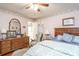 Inviting bedroom with a bed, dresser, mirror, nightstand, and ceiling fan at 1526 N Cherokee N Rd, Social Circle, GA 30025