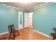 Bedroom showcasing hardwood floors and green walls, complete with a door and mirror at 1526 N Cherokee N Rd, Social Circle, GA 30025