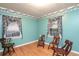 Bedroom featuring hardwood floors, green walls, and decorative floral wallpaper border at 1526 N Cherokee N Rd, Social Circle, GA 30025