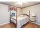 Cozy bedroom with a four-post bed, nightstand, hardwood floors, and natural light at 1526 N Cherokee N Rd, Social Circle, GA 30025