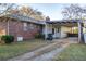 A brick ranch home with a carport and gravel driveway at 1526 N Cherokee N Rd, Social Circle, GA 30025