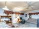 Cozy living room featuring a ceiling fan, a sofa, recliner, desk and natural light at 1526 N Cherokee N Rd, Social Circle, GA 30025