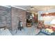 Inviting living room with brick wall, plush seating, ceiling fan, and natural light at 1526 N Cherokee N Rd, Social Circle, GA 30025