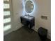 Modern bathroom with a floating vanity, rounded mirror, and a sleek black toilet at 2719 Winding Ne Ln, Brookhaven, GA 30319