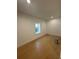 Well-lit bedroom with hardwood floors and a single window offering natural light at 2719 Winding Ne Ln, Brookhaven, GA 30319