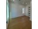 A well-lit bedroom with neutral walls, hardwood floors and a modern door at 2719 Winding Ne Ln, Brookhaven, GA 30319