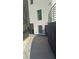 View of a modern home's driveway and minimalist side yard at 2719 Winding Ne Ln, Brookhaven, GA 30319
