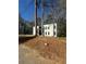 Modern home with a minimalist aesthetic and clean lines, nestled among mature trees on a sunny day at 2719 Winding Ne Ln, Brookhaven, GA 30319