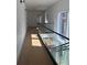 Spacious hallway with hardwood floors, glass railings, and ample natural light from large windows at 2719 Winding Ne Ln, Brookhaven, GA 30319