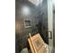 A modern shower featuring dark gray tiles and a sleek glass door provides a luxurious bathing experience at 2719 Winding Ne Ln, Brookhaven, GA 30319