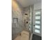 Contemporary bathroom with a frameless glass shower and gray tile accents at 2719 Winding Ne Ln, Brookhaven, GA 30319