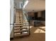 Modern staircase with glass railings and hardwood treads, flowing into the kitchen at 2719 Winding Ne Ln, Brookhaven, GA 30319