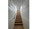 Classic staircase design with white wainscoting and hardwood steps, combining elegance and functionality at 2719 Winding Ne Ln, Brookhaven, GA 30319