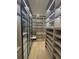 A luxurious walk-in closet featuring custom shelving, glass-door cabinets, and elegant lighting for style at 2719 Winding Ne Ln, Brookhaven, GA 30319