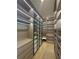 A well-organized walk-in closet with custom shelving, drawers, and glass-fronted cabinets, illuminated with modern lighting at 2719 Winding Ne Ln, Brookhaven, GA 30319