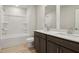 Modern bathroom with double vanity, large mirror, and a tub shower combo at 3913 Brushy St, Powder Springs, GA 30127