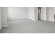 Large bedroom with grey carpet and an open door to the hallway at 3913 Brushy St, Powder Springs, GA 30127